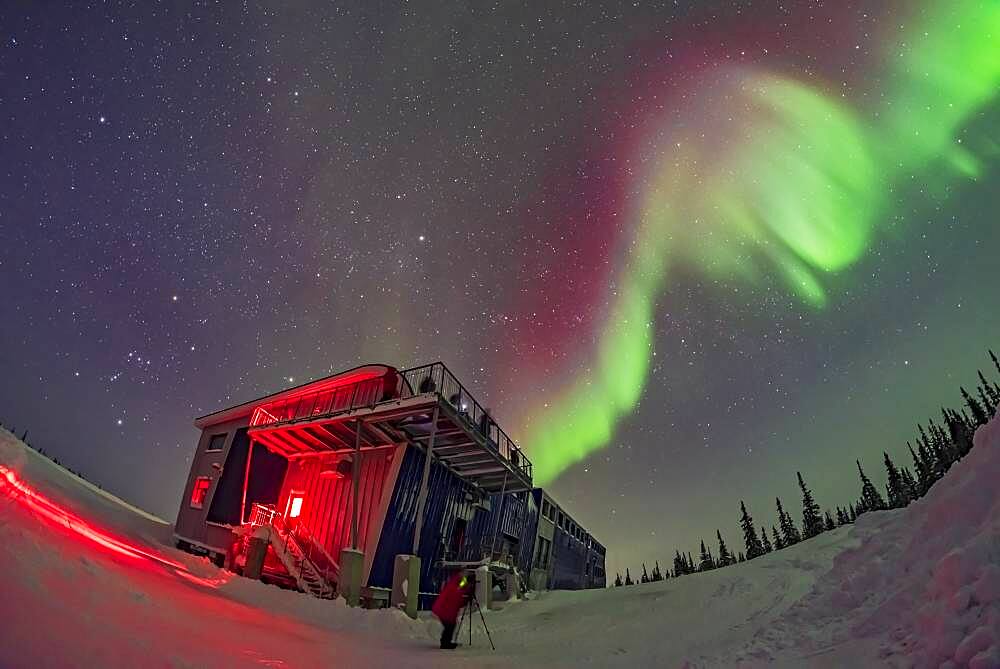 Orion and the winter sky, at left, and a swirl of colourful aurora over the Churchill Northern Studies Centre, in a display on February 11, 2018. People from the first Learning Vacations group of the season are shooting the Lights.