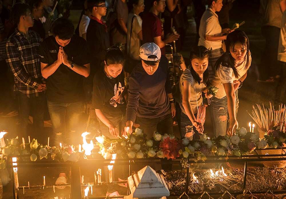 Believers praying, in Wat Phra Singh temple, Chiang Mai, Thailand