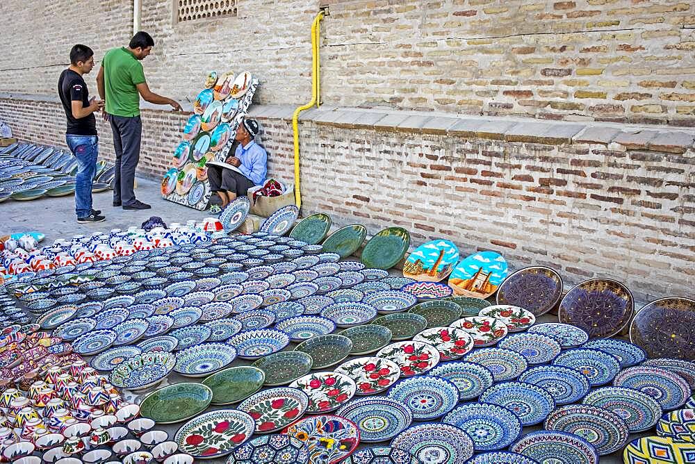 Craftsman selling traditional uzbek pottery, Bukhara, Uzbekistan