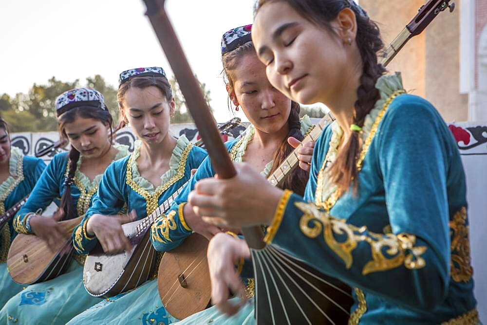 women playing dutar, folk show,in Rukhobod Mausoleum, Samarkand, Uzbekistan