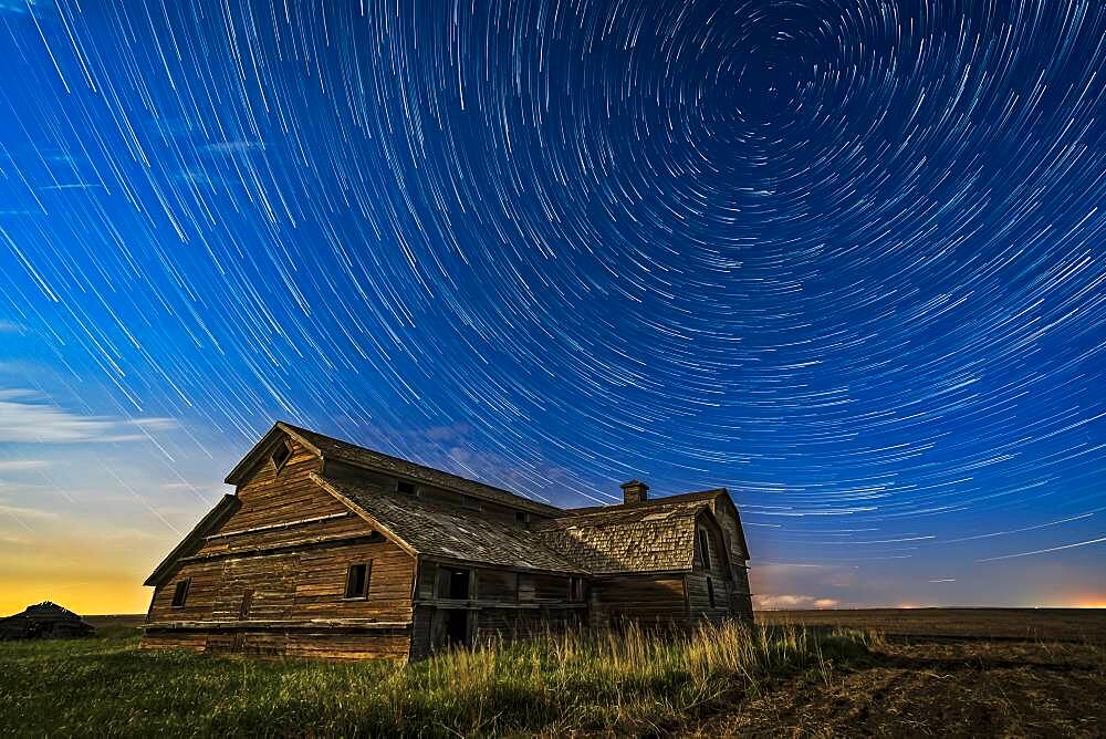 Circumpolar star trails over a grand old barn in southern Alberta, on a fine spring night, May 23, 2018. Illumination is from the waxing gibbous Moon to the south. This is looking north to Polaris at top right. A thunderstorm is on the northern horizon with a lightning bolt as a bonus.