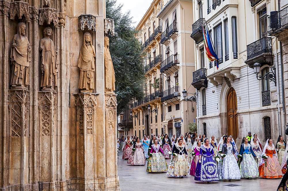 Flower offering parade,People with Floral tributes to `Virgen de los desamparados��, Fallas festival,carrer del Micalet street,Valencia