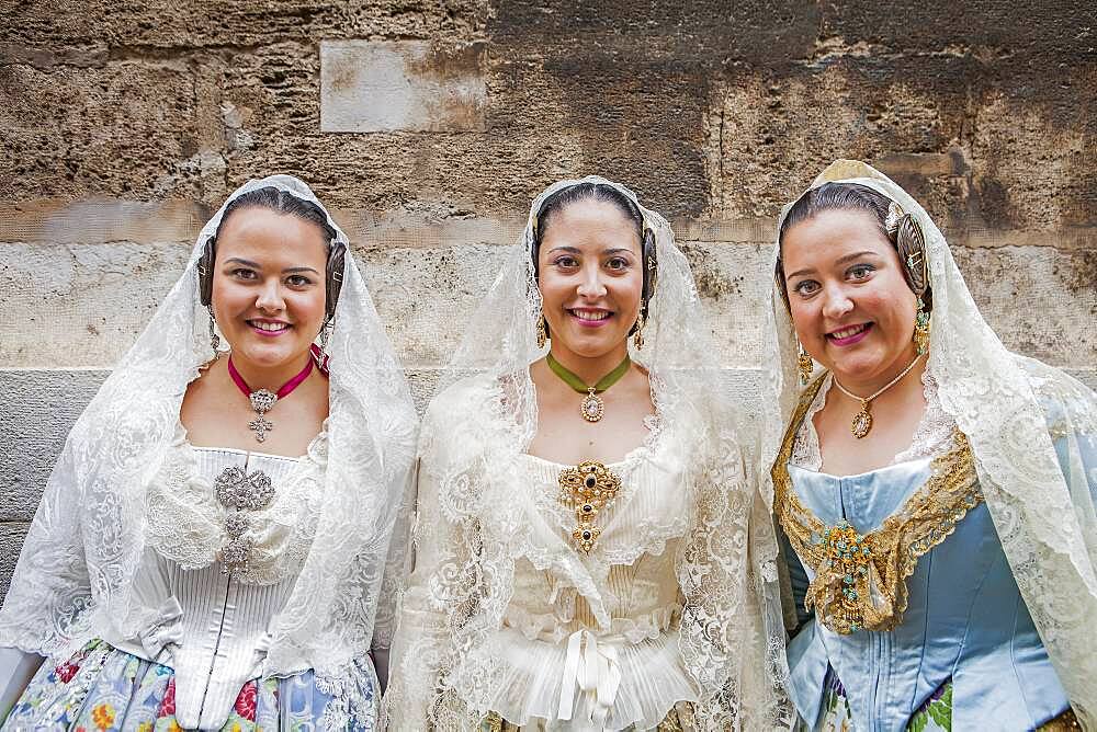 Women in Fallera Costumes during Flower offering parade, tribute to `Virgen de los desamparados��, Fallas festival, Plaza de la Virgen square,Valencia