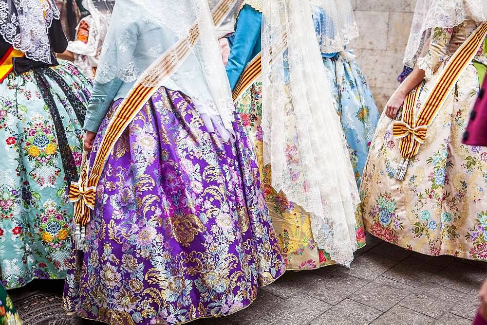 Detail, women in Fallera Costumes during Flower offering parade, tributes to `Virgen de los desamparados��, Fallas festival, Plaza de la Virgen square,Valencia