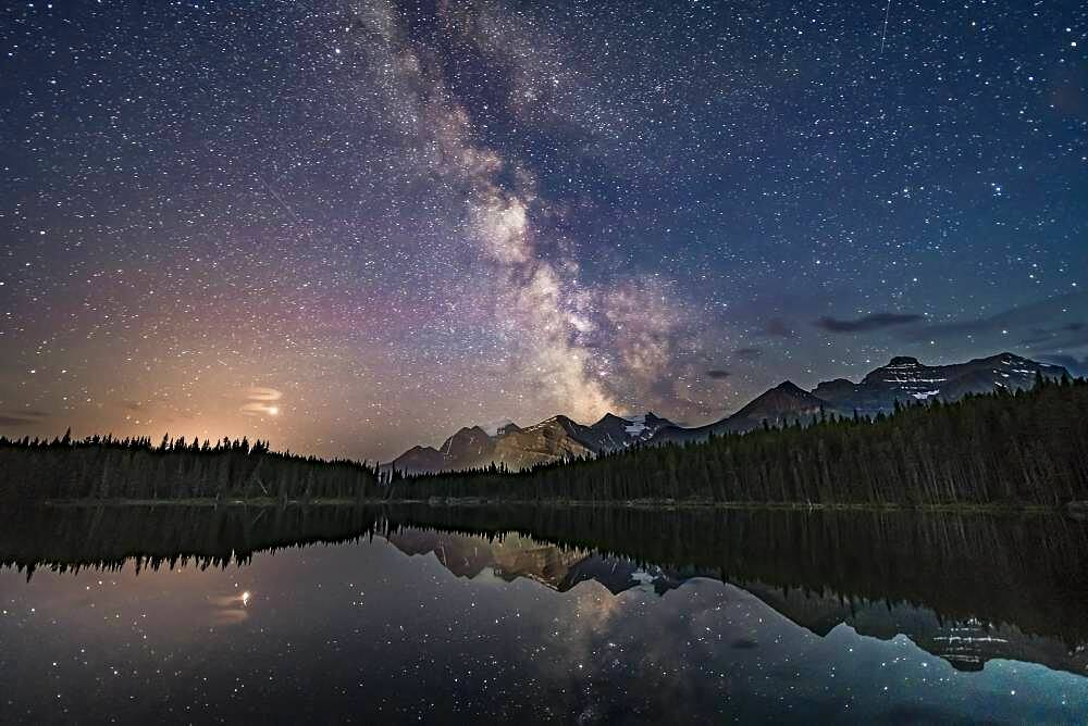 Mars (at left in clouds) and the summer Milky Way over Lake Herbert and reflected in the still waters this night. This is in Banff National Park, Alberta. I shot this July 17, 2018 on a night that gradually clouded up, after a run of two very good nights previous to this.