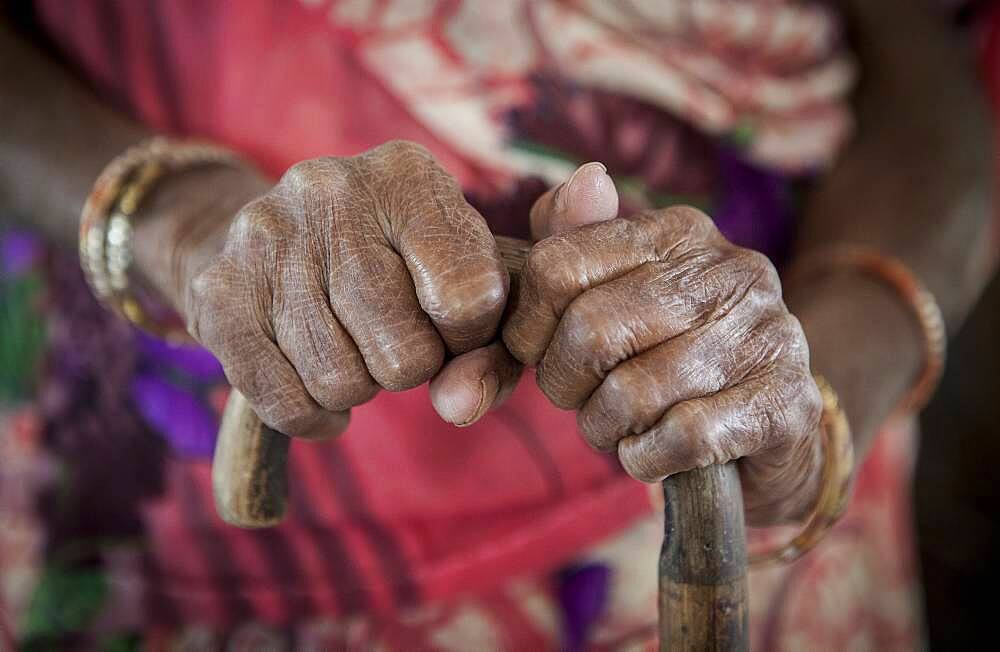 hands of Mrs Kambeti (widow), in Ma Dham ashram for Widows of the NGO Guild for Service, the NGO proposes at widows to wear colorful clothes,  Vrindavan, Mathura district, India