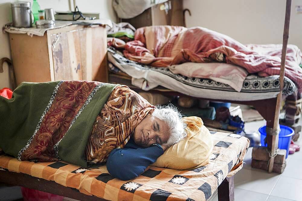 Widows sleeping, in Ma Dham ashram for Widows of the NGO Guild for Service, Vrindavan, Mathura district, India