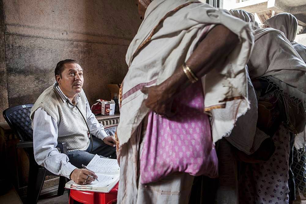 Dr.Ghopal;  Doctor of NGO SOS Woman examining widows, Vrindavan, Mathura district, India