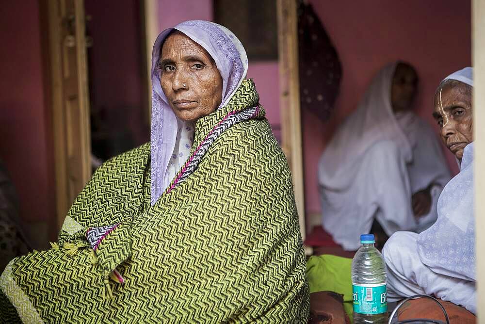 Widows praying in an ashram, Vrindavan, Mathura district, India