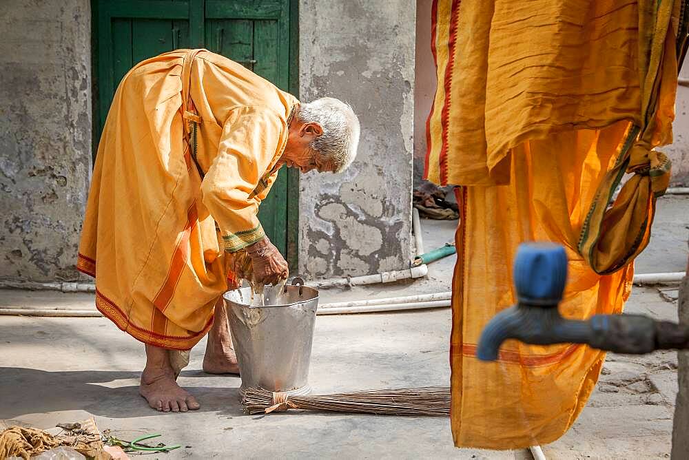 Window washing clothes on the street, facing the room where resides,  Vrindavan, Mathura district, India