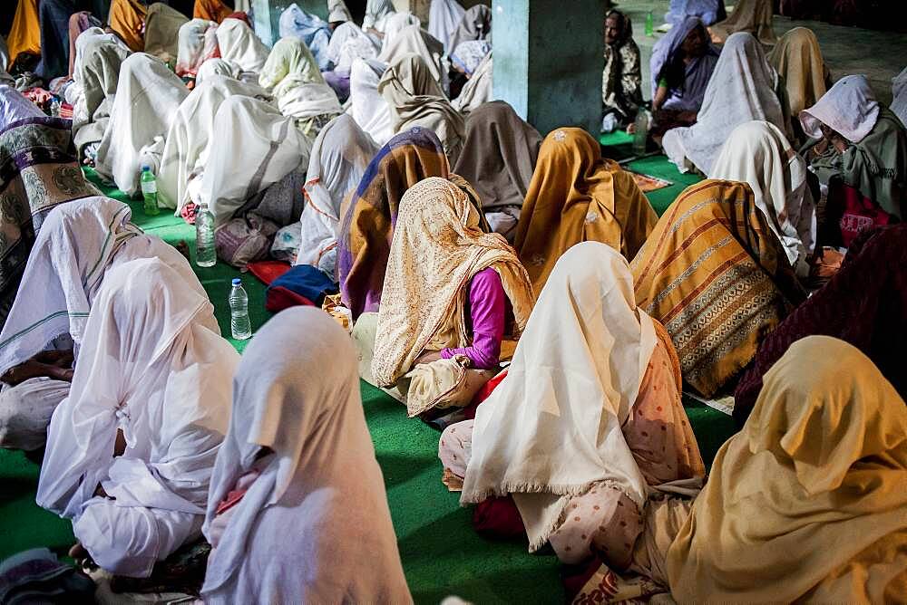 Widows praying in a Bhajan ashram, Vrindavan, Mathura district, India