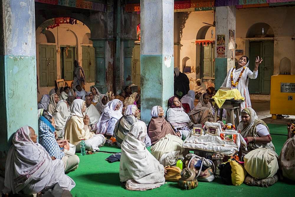 Widows praying in a Bhajan ashram, Vrindavan, Mathura district, India