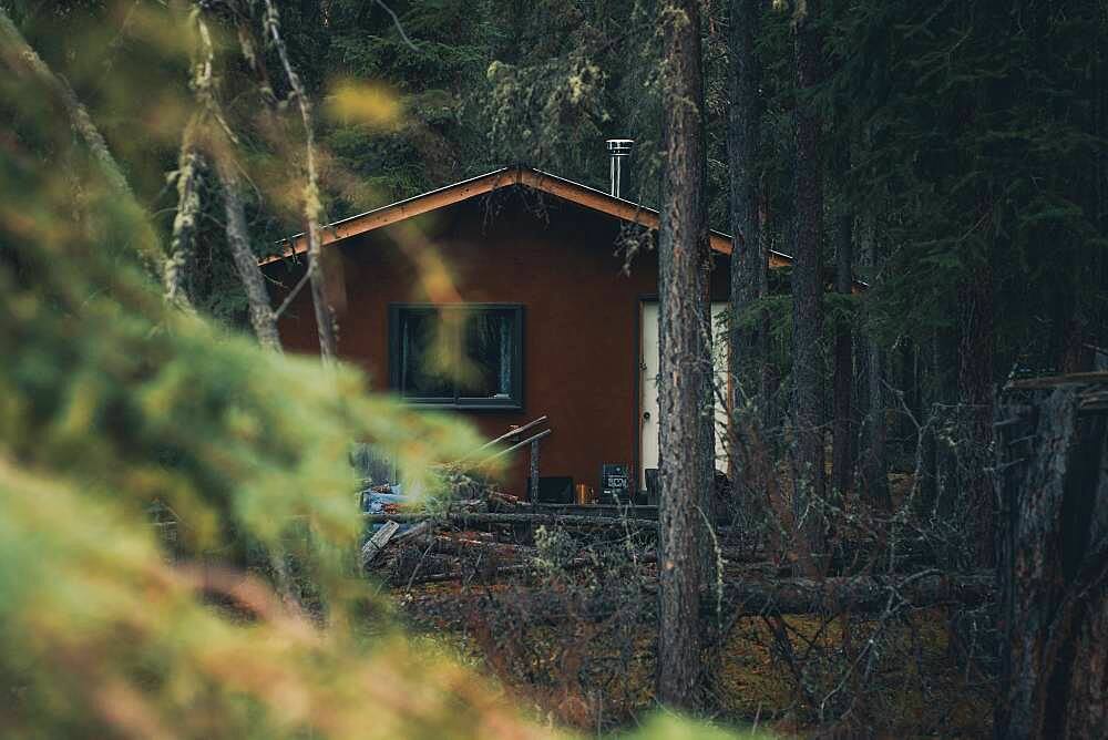 A simple trapper cabin in the woods of the Yukon Territory. Canada