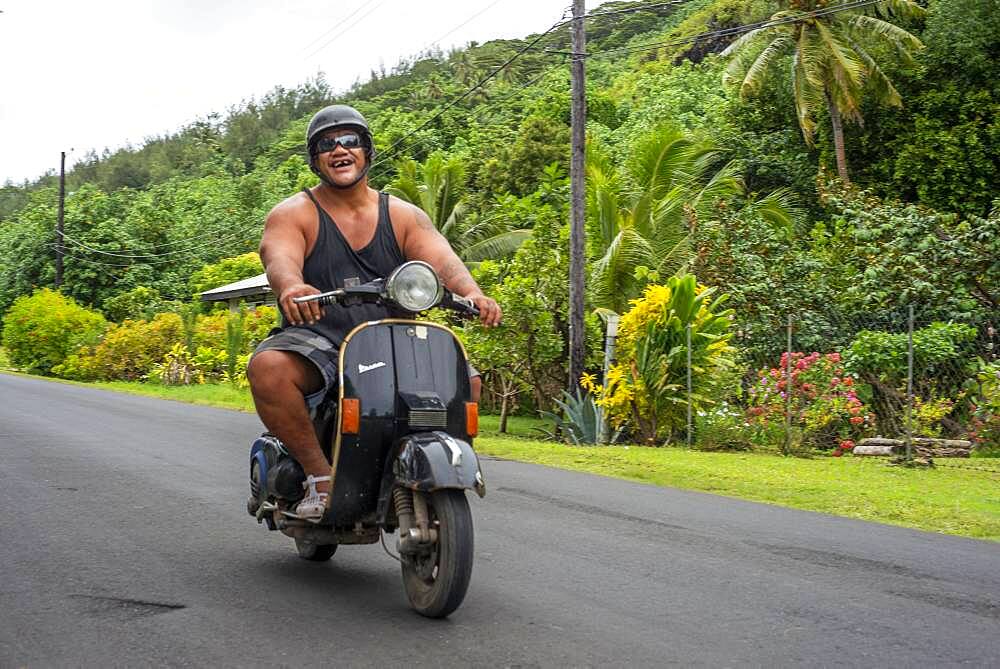 Portrait of a local fat man wirh motorbike in Huahine, Society Islands, French Polynesia, South Pacific.