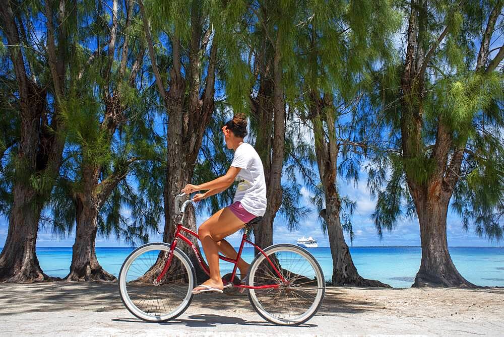 Local girl with a bike in Fakarava,  Tuamotus Archipelago French Polynesia, Tuamotu Islands, South Pacific.