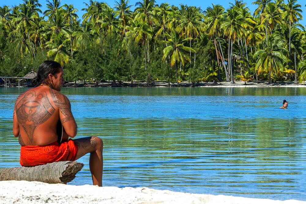 Island of Taha'a, French Polynesia. A local boy plays the ukulele to woo your girl at the Motu Mahana, Taha'a, Society Islands, French Polynesia, South Pacific.