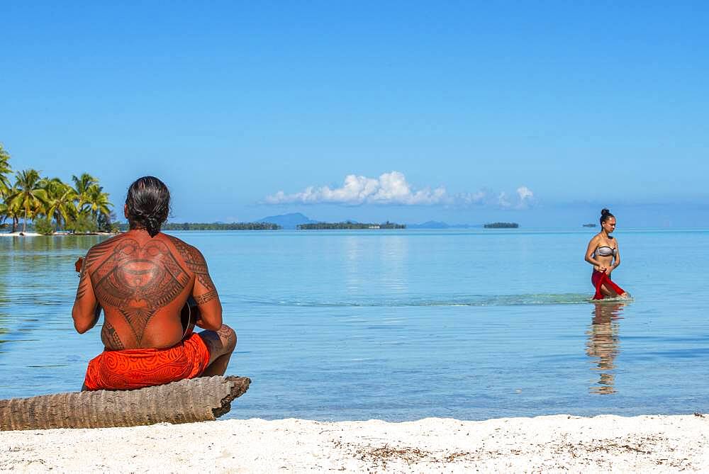 Island of Taha'a, French Polynesia. A local boy plays the ukulele to woo your girl at the Motu Mahana, Taha'a, Society Islands, French Polynesia, South Pacific.