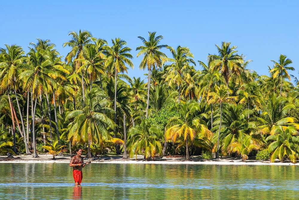 Island of Taha'a, French Polynesia. A local boy plays the ukulele to woo your girl at the Motu Mahana, Taha'a, Society Islands, French Polynesia, South Pacific.