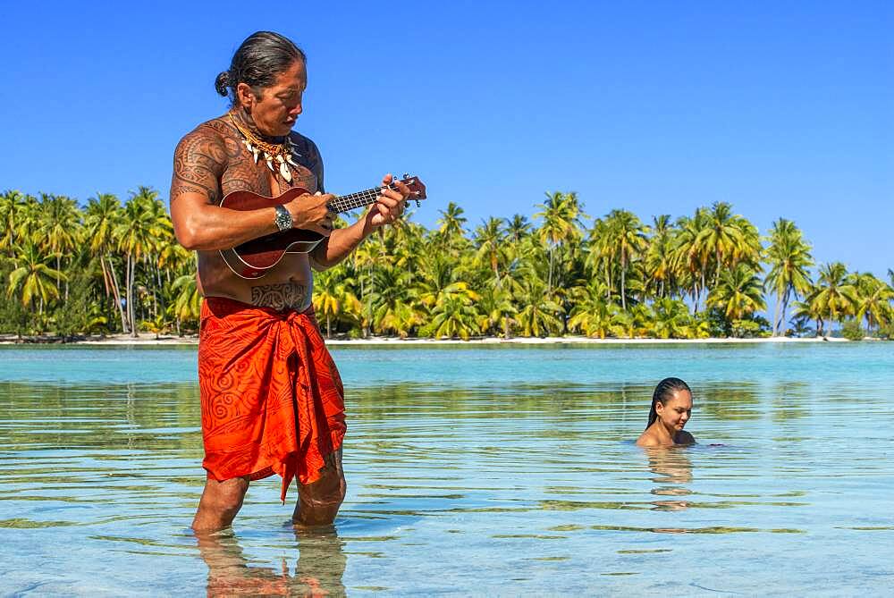 Island of Taha'a, French Polynesia. A local boy plays the ukulele to woo your girl at the Motu Mahana, Taha'a, Society Islands, French Polynesia, South Pacific.