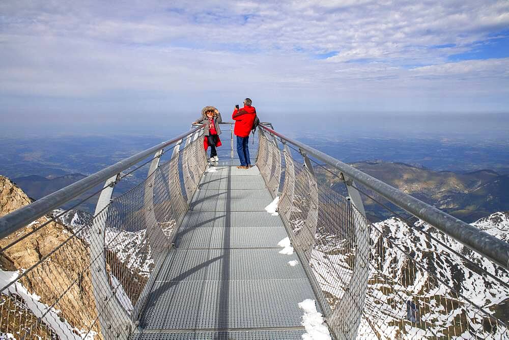 View point of The Observatory Of Pic Du Midi De Bigorre, Hautes Pyrenees, Midi Pyrenees, France. The 12m Ponton dans le ciel, a glass walkway high above the Pyrenees at Pic du Midi de Bigorre, a 2877m mountain in the French Pyrenees, home to an astronomical observatory and visitors centre. The observatory is acccessible from the village of La Mongie by cablecar. Tourists often visit in time for the spectacular sunset across the mountains.