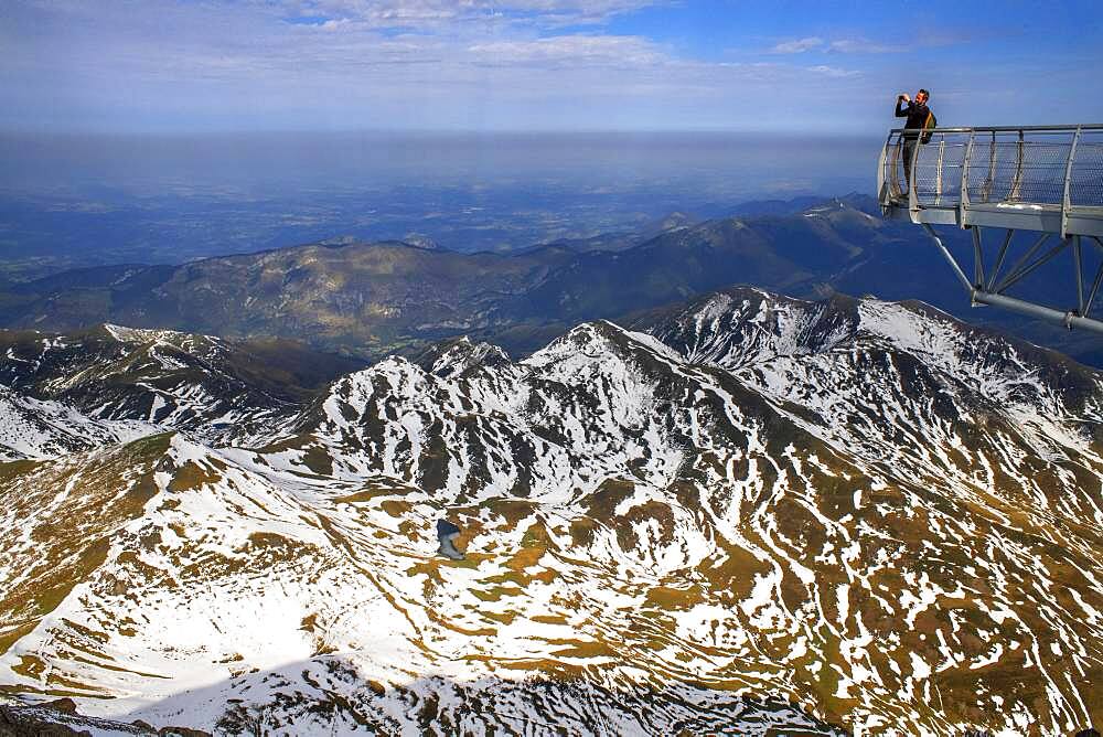 View point of The Observatory Of Pic Du Midi De Bigorre, Hautes Pyrenees, Midi Pyrenees, France. The 12m Ponton dans le ciel, a glass walkway high above the Pyrenees at Pic du Midi de Bigorre, a 2877m mountain in the French Pyrenees, home to an astronomical observatory and visitors centre. The observatory is acccessible from the village of La Mongie by cablecar. Tourists often visit in time for the spectacular sunset across the mountains.