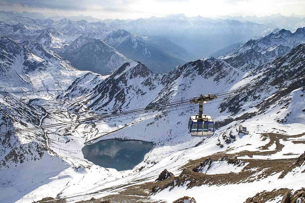 La Mongie lake of Oncet and a cable car rising to The Observatory Of Pic Du Midi De Bigorre, Hautes Pyrenees, Midi Pyrenees, France