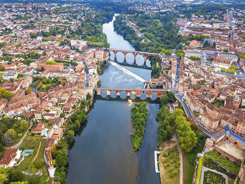 The Tarn River crossing Albi town. Pont Vieux bridge and the Church of Notre Dame du Breuil in Tarn village, Occitanie Midi Pyrenees France.