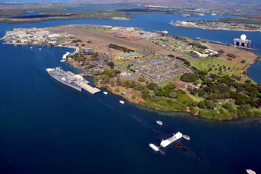 Aerial view of Ford Island with Arizona Memorial and USS Missouri, the "Mighty Mo" ship, docked at Pearl Harbor, Oahu, Hawaii, USA