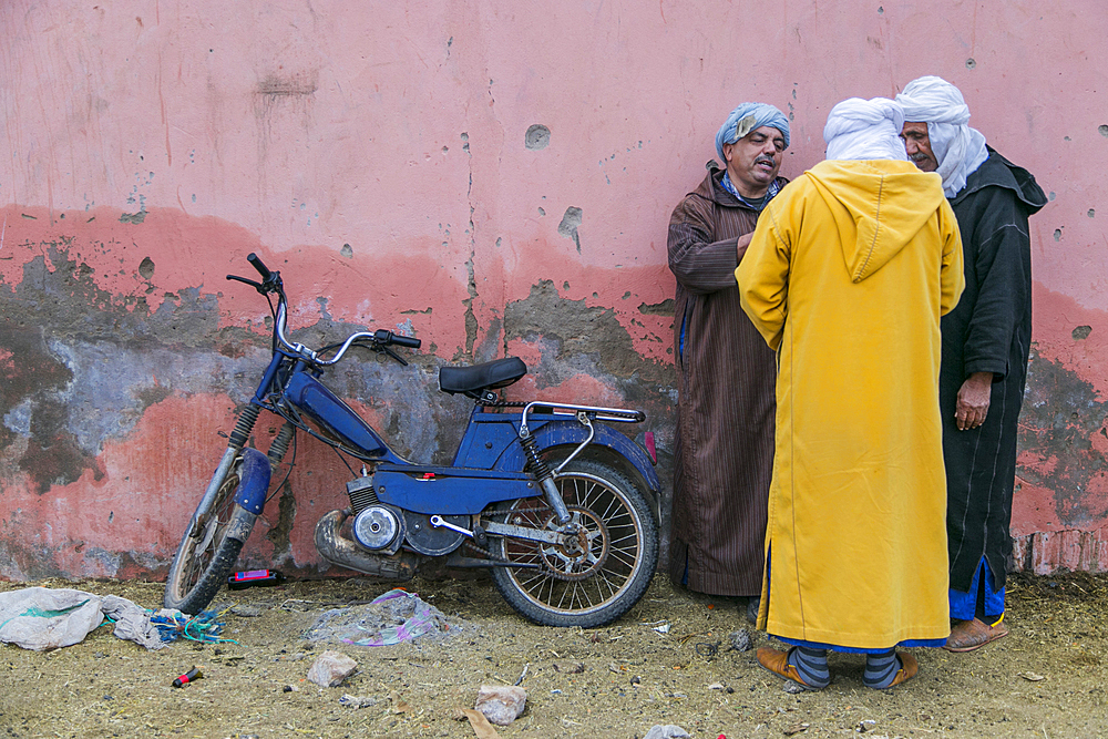 Three men trading in the animal market in Guelmim