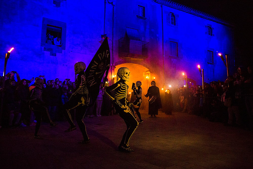 Verges, a small town in the Northeast of Catalonia (Spain), during Easter celebrates the Procession of Verges with skeletons dancing on the sound of a drum, Roman soldiers, known as the 'Manages', and a representation of the life and crucifixion of Jesus Christ. The Procession features the Dance of Death, a tradition from the Middle Age associated with epidemics and plagues and the only one remaining in Spain Ten skeletons dance to the beat of a drum to remember that no one is exempt of death. The backdrop of the medieval walls and towers of Verges is key to this macabre staging.