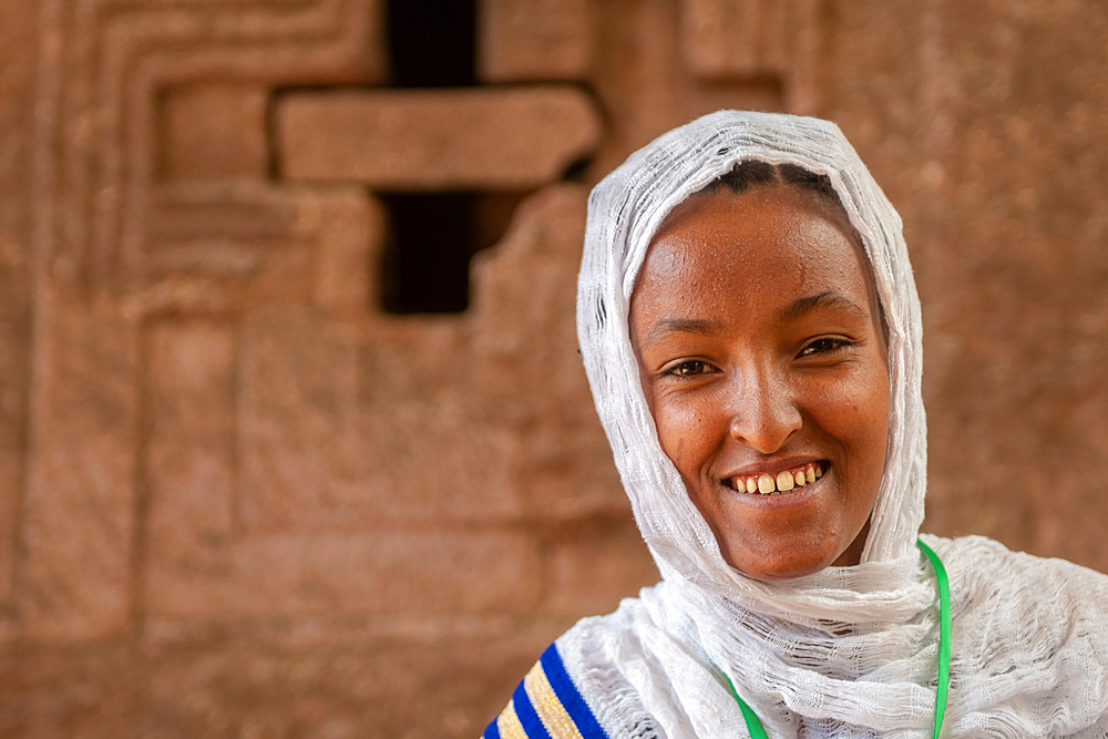 Portrait of an Ethiopian woman outside of the rock hewn monolithic church of Bet Maryam (Church of St. Mary) in Lalibela, Ethiopia