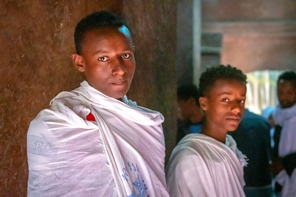 A pair of young men in shawls inside of Bet Giyorgis (Church of St. George) in Lalibela, Ethiopia