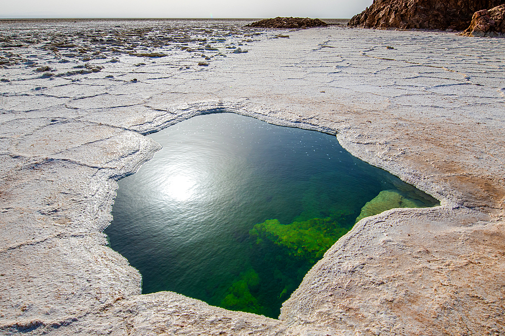 Water of Lake Karum, visible through a hole in the salt flat, Danakil Depression, Ethiopia.