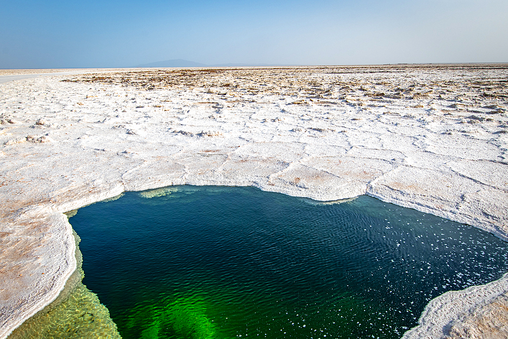 Water of Lake Karum, visible through a hole in the salt flat, Danakil Depression, Ethiopia.