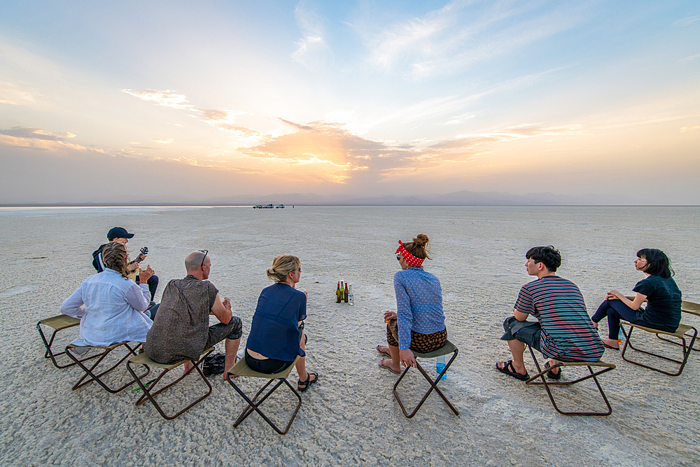 Tourists stop to drink and rest in the salt flats of the Danakli depression, Ethiopia.