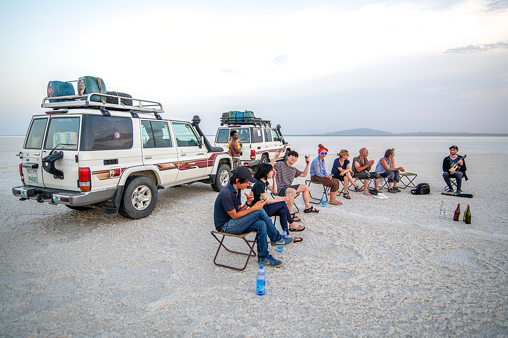 Tourists stop to drink and rest in the salt flats of the Danakli depression, Ethiopia.