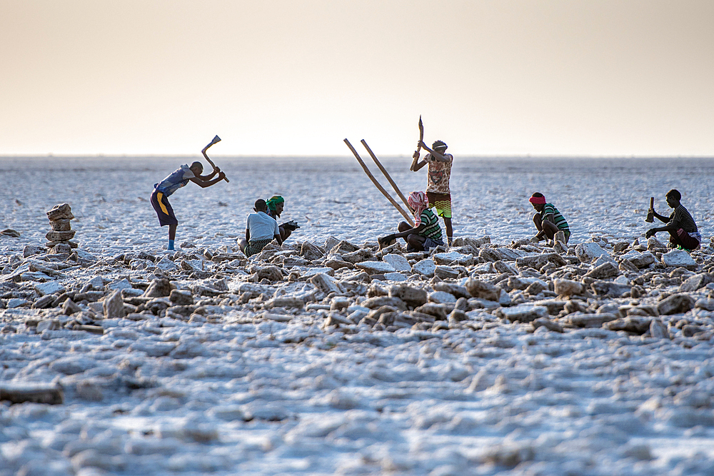 Salt miners dig away at the salt flats in the Danakil Depression, Ethiopia.