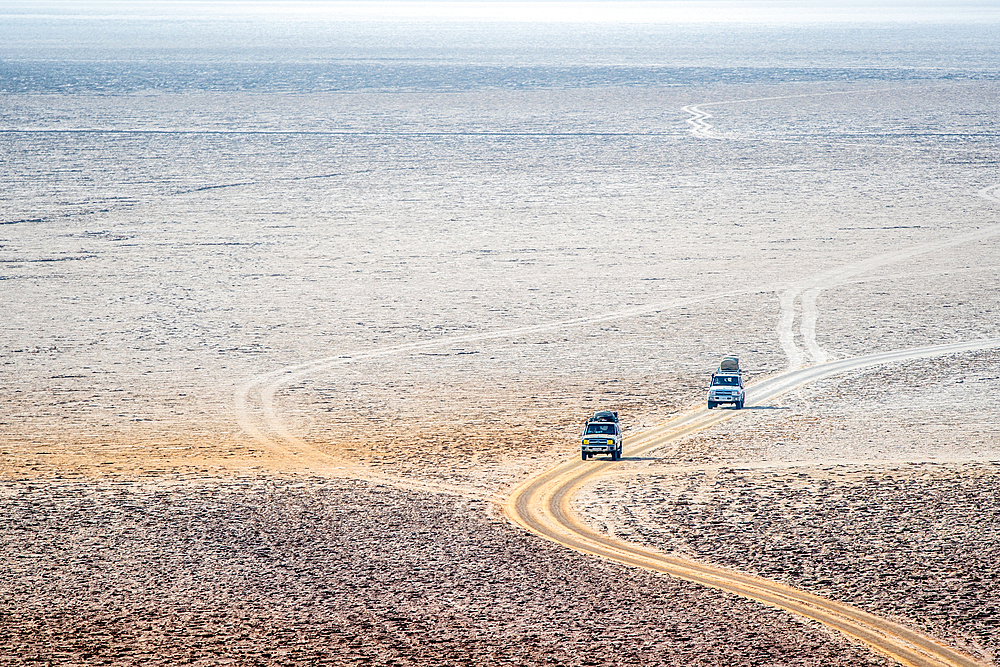 Vehicles and the salt flats in the Danakil Depression, Ethiopia