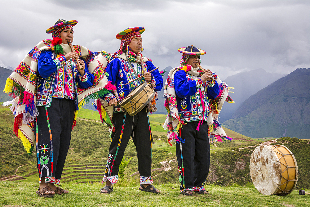 Quechua men in traditional clothing with musical instruments in performance at El Parador de Moray, Sacred Valley, Peru.