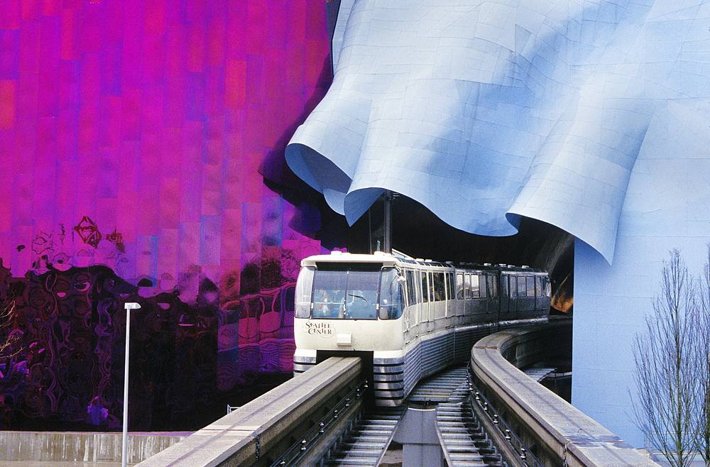 Monorail emerging from tunnel through Experience Music Project at Seattle Center; Seattle, Washington.