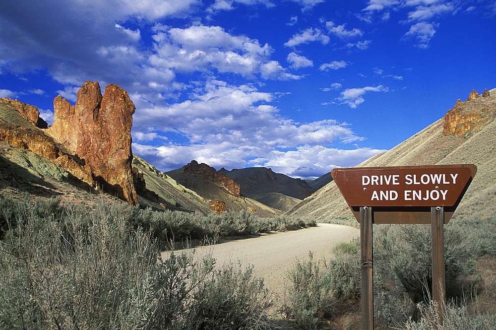 ?Drive Slowly and Enjoy? sign on dirt road in Leslie Gulch, southeast Oregon.