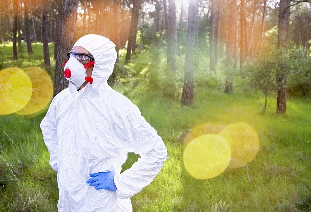 Person with a safety suit in a forest area. Ayegui, Navarre, Spain, Europe