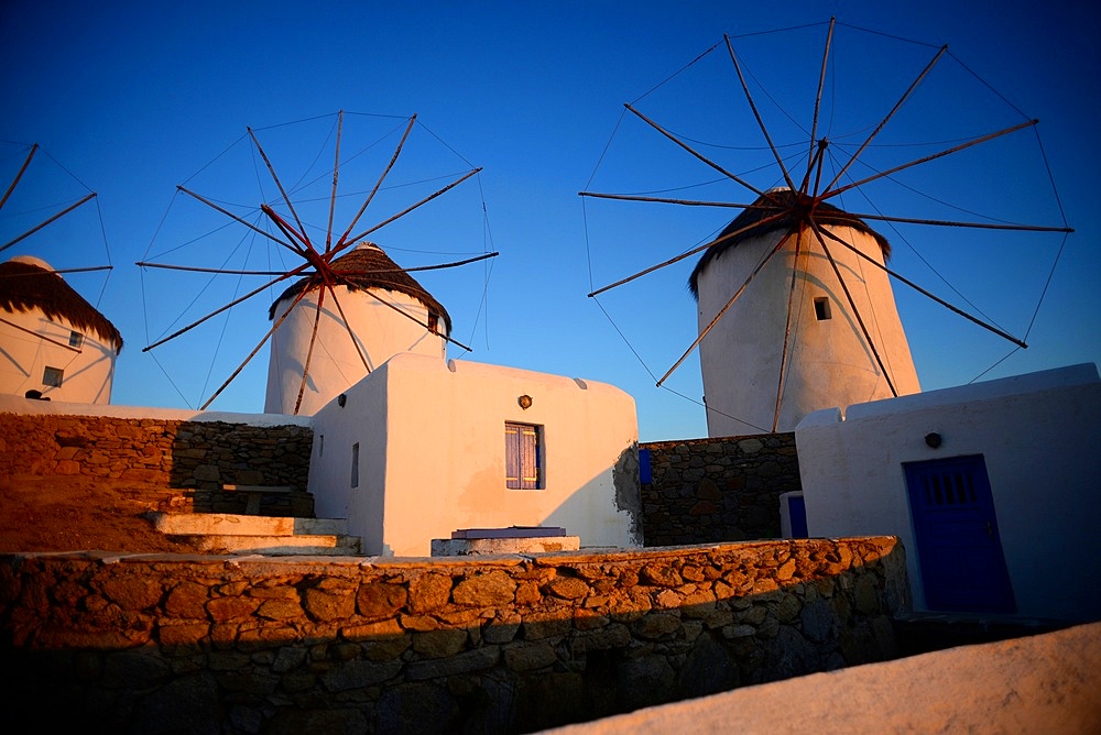 Traditional windmills (Kato Milli) at sunset in Mykonos town, Greece