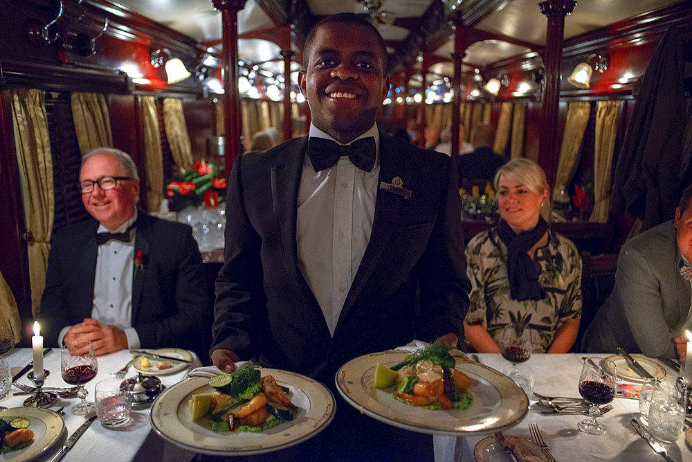 Passengers having dinner in the restaurant car of the The Rovos Rail luxury train travelling between Cape Town and Pretoria in South Africa Pride of Africa beautifully rebuilt Classic train that form part of the luxurious and privately owned Rovos Rail fleet