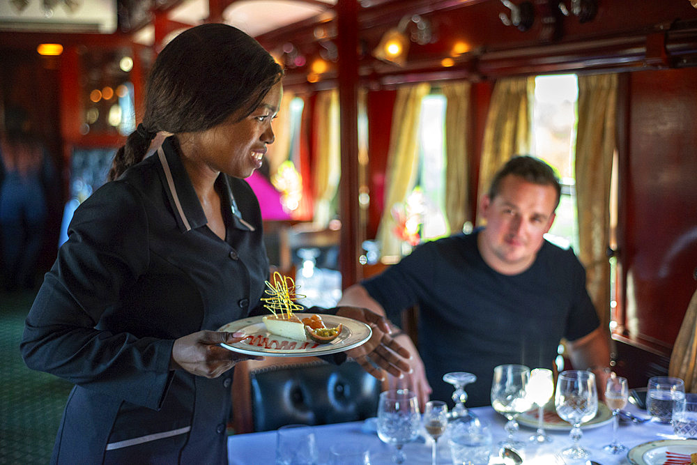 Passengers having lunch in the restaurant car of the The Rovos Rail luxury train travelling between Cape Town and Pretoria in South Africa Pride of Africa beautifully rebuilt Classic train that form part of the luxurious and privately owned Rovos Rail fleet