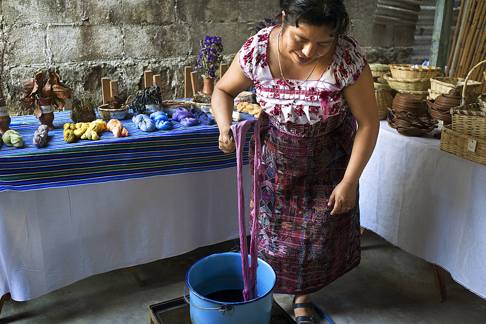 A Mayan woman use natural dyes to color fabrics. Ixoq Ajkeem comunity, San Juan La Laguna, Solol√°, Guatemala. Santiago Atitlan, lake Atitlan, Guatemala.