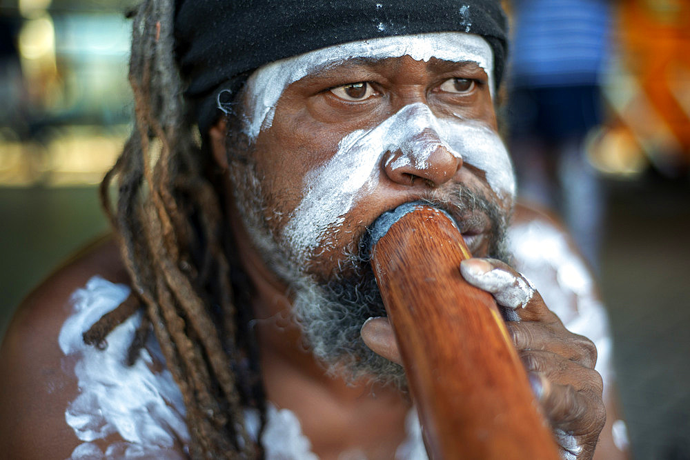 Australian Aboriginal dressed man selling music cd in The Rocks area at Circular Quay in Sydney New South Wales, Australia