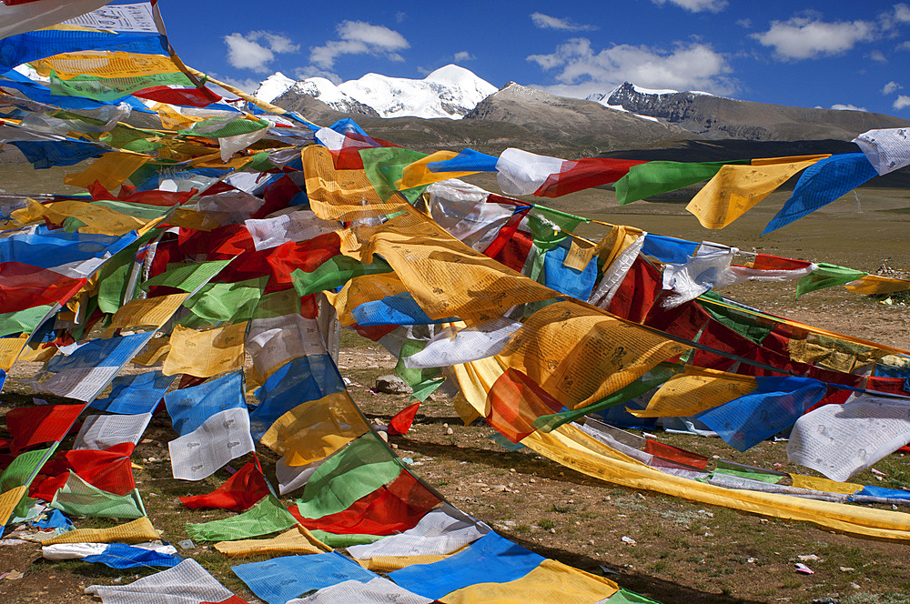 La Ken La pass or Laken pass at 5190 metres on the road to remote Nam Tso Lake Tibet. Namtso Lake Tibet China. Prayer flags next to the base of Mount Nyenchen Tanglha 7111 meters high, Tibet China. One of the holy mountains for Tibetans. The Nyenchen Tanglha is the highest peak of the Nyainqentanglha mountain. It is located near Lhasa, on the Qinghai-Tibet paved road. It is surrounded by grassy plains from Damshung to the south and to the picturesque sacred Nam Tso Lake (4,700 m, one of the largest lakes in the world) in the north.