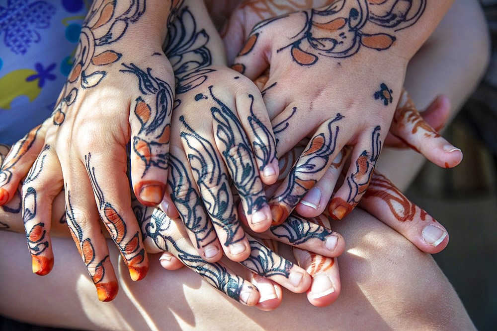 Girls shows the hands Painted With Henna And Indigo in Lamu, Lamu Archipelago, Kenya