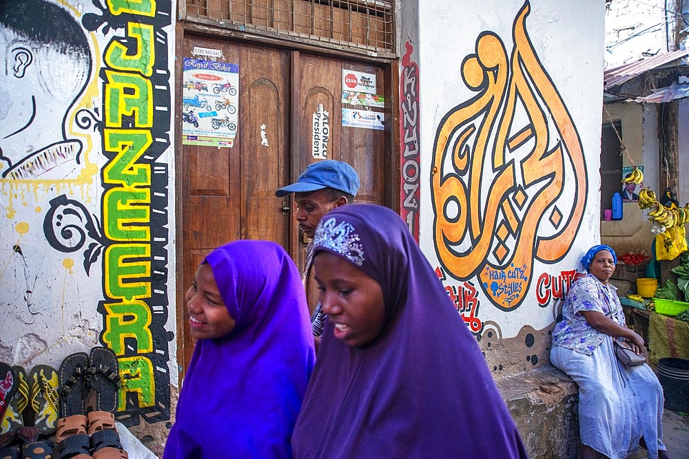 Local people small shops and houses and narrow strees of the city town of Lamu in Kenya